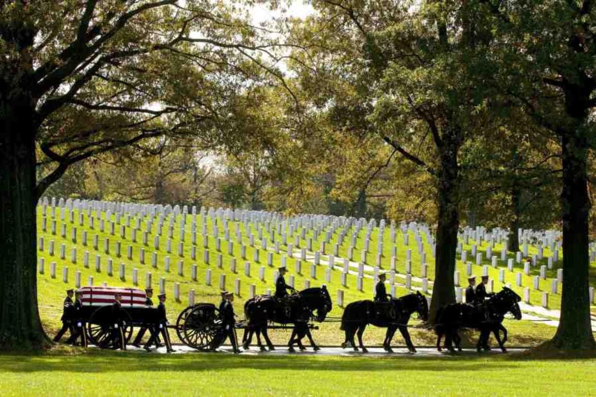 FILE - A U.S. Army Caisson team carries the remains of Army Pfc. Tramaine J. Billingsley during burial services at Arlington National Cemetery in Arlington, Va., Nov. 2, 2010. The return of horse-drawn caissons at Arlington National Cemetery is being delayed for at least months or a year, the Army said Friday, April 12, 2024, as officials struggle to improve the care of the horses, after two died in 2022 as a result of poor feed and abysmal living conditions.