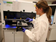 Liza Knez, a senior technologist at the Kaiser Permanente Northern California Regional Laboratory, demonstrates the use of a cell free DNA analysis unit on Monday, April 1, 2023, in San Jose, California. The new genomics lab will expand diagnostic testing capabilities and provide early screening and intervention for its 4.5 million members.