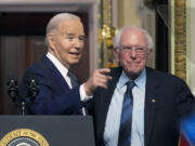 President Joe Biden stands with Sen. Bernie Sanders, I-Vt., after speaking about lowering health care costs in the Indian Treaty Room at the Eisenhower Executive Office Building on the White House complex in Washington, Wednesday, April 3, 2024.