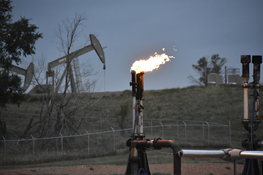 FILE - A flare to burn methane from oil production is seen on a well pad near Watford City, N.D., on Aug. 26, 2021. Oil and gas companies will have to pay more to drill on public lands and satisfy stronger requirements to clean up old or abandoned wells under a final rule issued Friday, April 12, 2024, by the Biden administration. The Interior Department rule does not go so far as to prohibit new oil and gas leasing on public lands, as many environmental groups have urged and as President Joe Biden promised during the 2020 campaign.