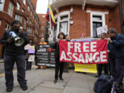 Protesters stand in front of the Ecuadorian Embassy  in London, Thursday, April 11, 2024, where Wikileaks founder Julian Assange was arrested five years ago. US President Joe Biden said Wednesday that he is considering a request from Australia to drop the decade-long U.S.