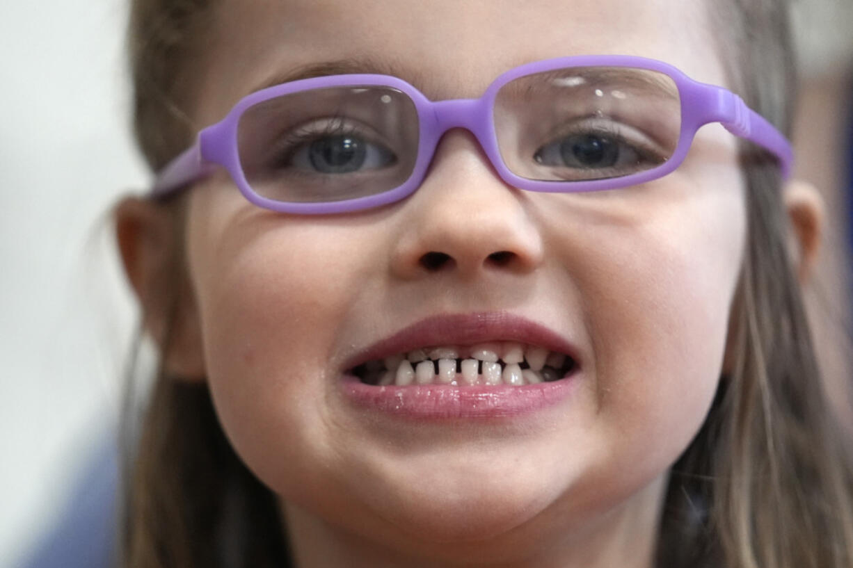 Amber Warner shows off her teeth after a dental exam at the Christa McAuliffe School in Concord, N.H., Wednesday, Feb. 21, 2024. The federal government and the dental community are increasing efforts to reach children at an early age. (AP Photo/Robert F.