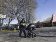 Nicole Slemp, a new mother of seven-month-old William, pushes her son in his stroller past KinderCare, which is near the family&rsquo;s home Thursday, March 14, 2024 in Auburn, Wash. Slemp recently quit her job because she and her husband couldn&rsquo;t find child care they could afford. Expensive, scarce child care is putting Puget Sound parents out of work. (Ellen M.