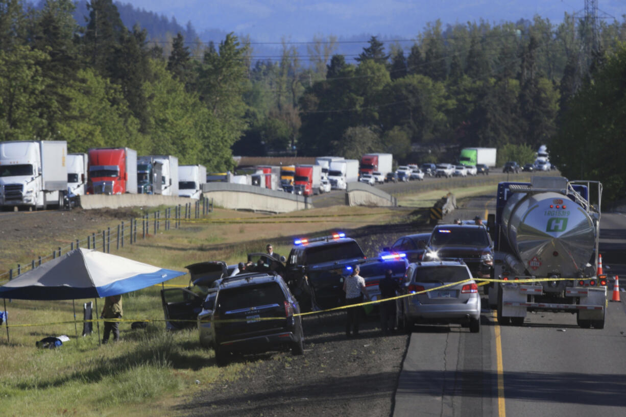 Traffic is backed up on Interstate 5 north of Eugene, Ore., as law enforcement secures the scene after a police chase Tuesday, April 23, 2024. A former Washington state police officer wanted after killing two people, including his ex-wife, was found dead with a self-inflicted gunshot wound following the chase, authorities said.