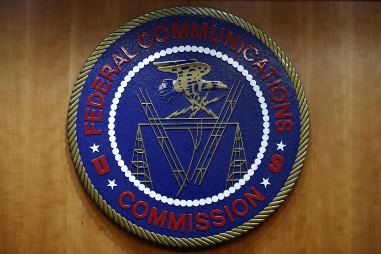 FILE - The seal of the Federal Communications Commission (FCC) is seen before an FCC meeting to vote on net neutrality, Dec. 14, 2017, in Washington. The FCC on Thursday, April 25, 2024 restored &ldquo;net neutrality&rdquo; rules that prevent broadband internet providers such as Comcast and AT&amp;T from favoring some sites and apps over others..