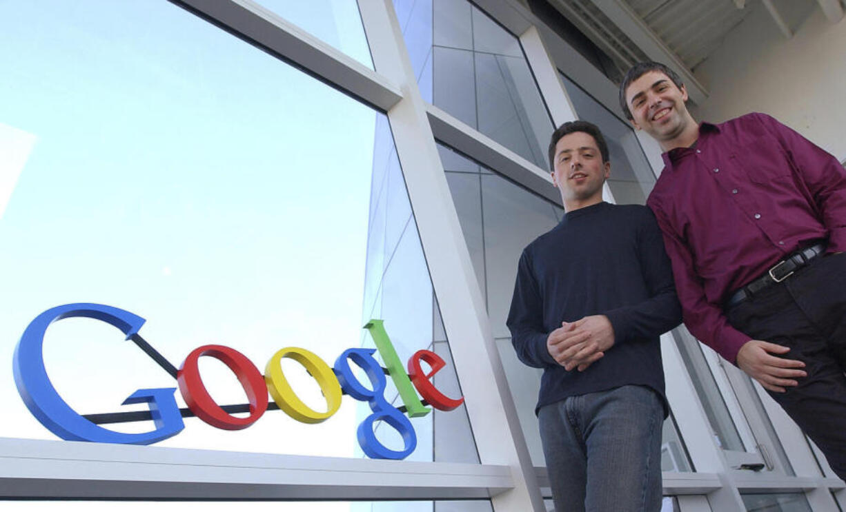 FILE - Google co-founders Sergey Brin, left, and Larry Page pose at company headquarters Jan.15, 2004, in Mountain View, Calif. Page and Brin unveiled Gmail 20 years ago on April Fool&rsquo;s Day.