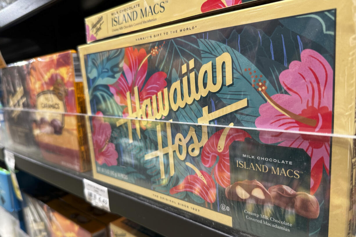 Packages of macadamia nuts are displayed on store shelves on Friday, April 26, 2024, in Honolulu. For decades, tourists to Hawaii have brought home gift boxes of the islands&rsquo; famous chocolate-covered macadamia nuts for friends and family.