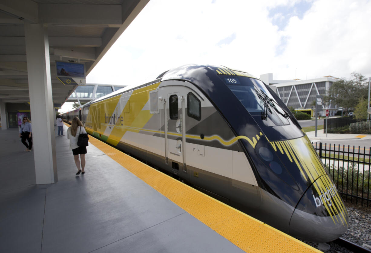 FILE - A Brightline train is shown at a station in Fort Lauderdale, Fla., on Jan. 11, 2018.  A fast-tracked plan to build a high-speed passenger rail line between Las Vegas and the Los Angeles area is set to mark the start of construction. Brightline West and U.S. transportation secretary and other officials projecting that millions of ticket-buyers will be boarding trains by 2028.
