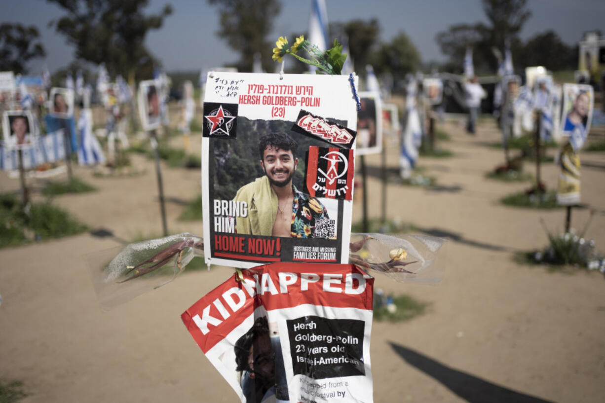 FILE - A poster depicting Israeli-American hostage Hersh Goldberg-Polin is displayed in Re&rsquo;im, southern Israel at the Gaza border, Feb. 26, 2024, at a memorial site for the Nova music festival site where he was kidnapped to Gaza by Hamas on Oct. 7, 2023. Hamas on Wednesday, April 24, 2023, released a recorded video of an Israeli American still being held by the group. The video was the first sign of life of Hersh Goldberg-Polin since Hamas&rsquo; Oct. 7 attack on southern Israel. It was not clear when the video was taken.