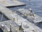 This undated photo released early Tuesday, April 30, 2024, by the U.S. military&rsquo;s Central Command shows construction off a floating pier in the Mediterranean Sea off the Gaza Strip. A U.S. Navy ship involved in the American-led effort to bring more aid into the besieged Gaza Strip is off shore from the enclave, slowly building out a floating platform for the operation, satellite photos analyzed Monday, April 29, 2024, by The Associated Press show. (U.S.