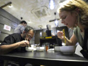 Diners eat noodles at Shinbusakiya, a ramen shop which offers &ldquo;Hokkaido classics,&rdquo; during Tokyo Ramen Tours at Shibuya district on April 2 in Tokyo.