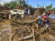 People try to clear the area after a dam burst, in Kamuchiri Village Mai Mahiu, Nakuru County, Kenya, Monday, April 29, 2024. Police in Kenya say at least 40 people have died after a dam collapsed in the country&rsquo;s west.