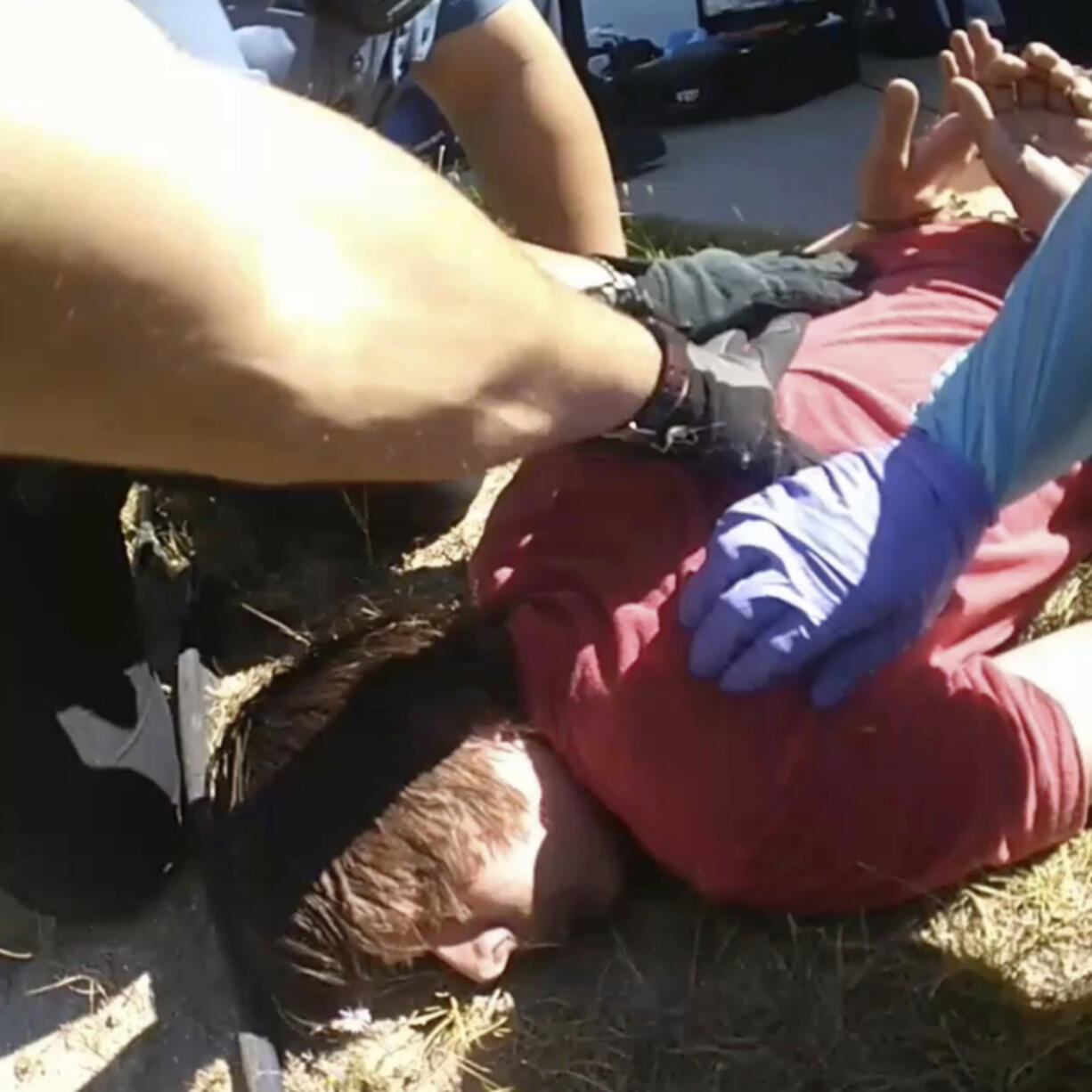 In this image from Colorado Springs Police Department body-camera video, police restrain Hunter Barr outside his father&rsquo;s home in Colorado Springs, Colo., on Sept. 25, 2020. Retired postal worker Mark Barr had called 911 for help controlling his son, who he said wasn&rsquo;t violent but was having a bad reaction to LSD. He watched as a medic gave two injections. His son was dead within hours. &ldquo;I couldn&rsquo;t figure out why that was necessary,&rdquo; he said of the second injection.