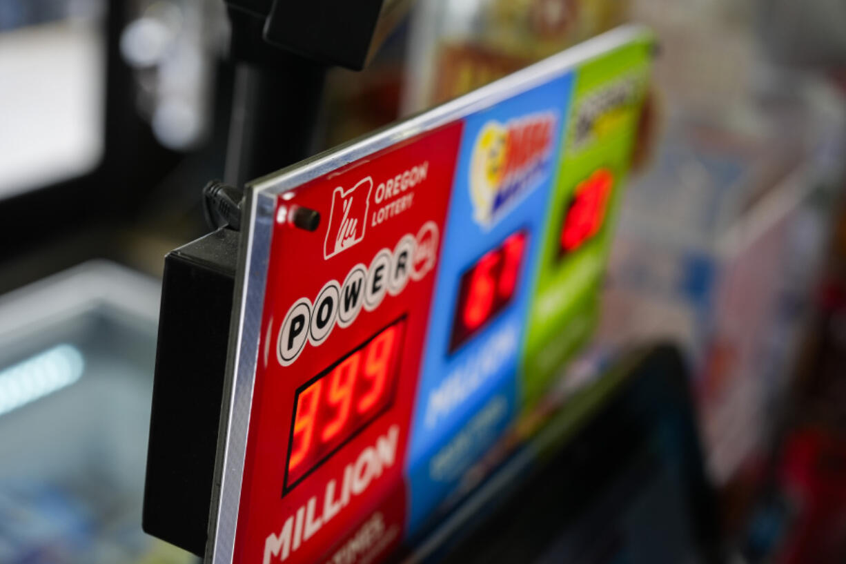 A sign for the Powerball jackpot is displayed at a 7-Eleven, Friday, April 5, 2024, in Portland, Ore.