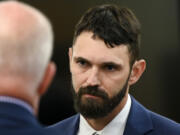 FILE - Christopher &quot;Shane&quot; Burbank speaks with an attorney and codefendants during the pre-trial motion in the trial of Tacoma police officers Matthew Collins, Timothy Rankine and Burbank in the killing of Manny Ellis, Sept. 18, 2023, at Pierce County Superior Court in Tacoma, Wash. Burbank, one of the three Tacoma police officers cleared of criminal charges in the 2020 death of Ellis, has been hired by a neighboring sheriff&#039;s office. The Thurston County Sheriff&#039;s Office announced Monday, April 1, 2024, that it had hired Burbank as a patrol deputy.