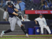 Seattle Mariners catcher Cal Raleigh (29) hits the game winning two run home run during the tenth inning of a baseball game against the Toronto Blue Jays in Toronto on Wednesday, April 10, 2024.