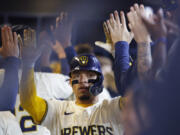 Milwaukee Brewers&#039; William Contreras (24) reacts after his two-run home run during the second inning of a baseball game against the Seattle Mariners Sunday, April 7, 2024, in Milwaukee.