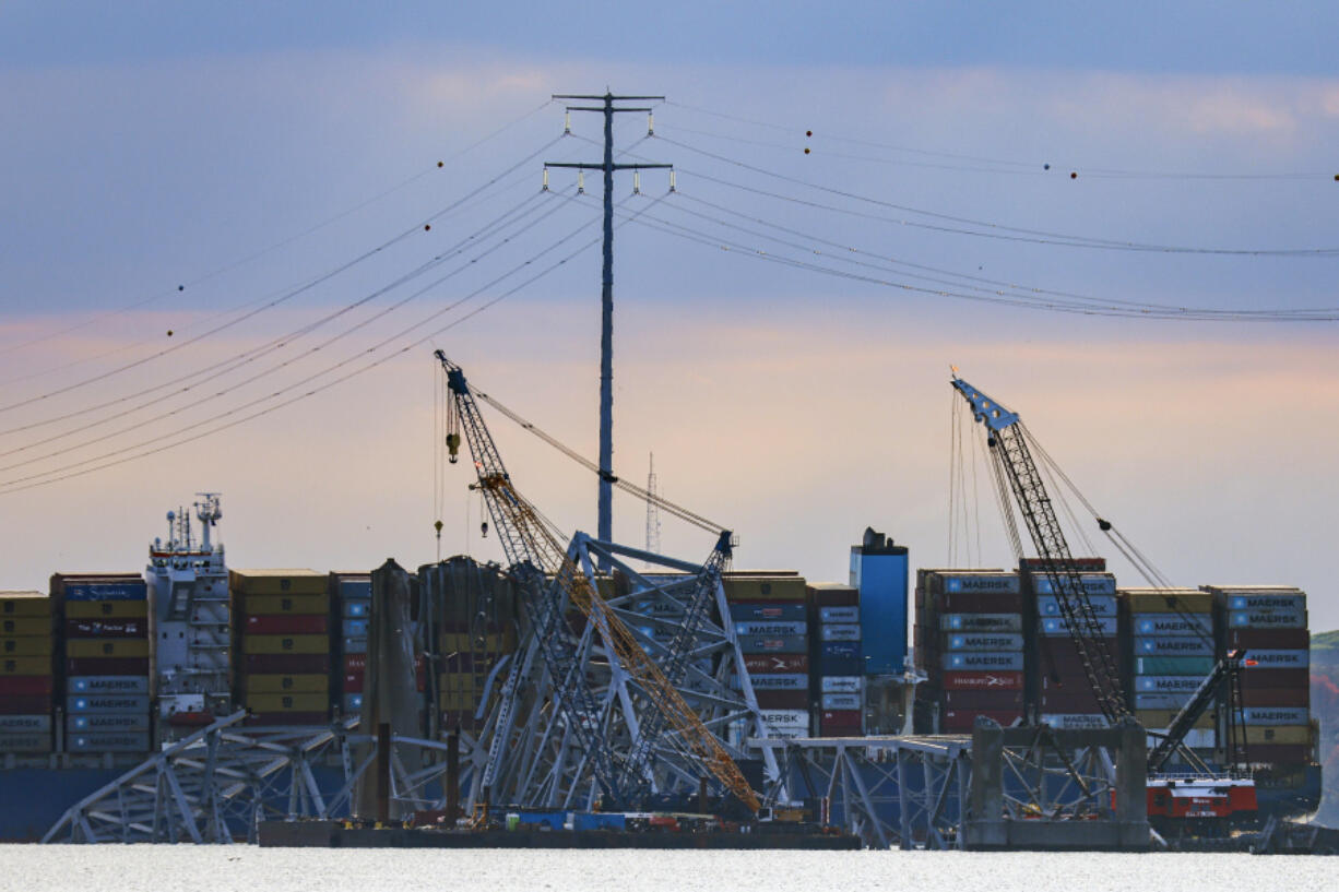 Workers start to remove a section of the collapsed Francis Scott Key Bridge, Sunday, March 31, 2024, in Baltimore.