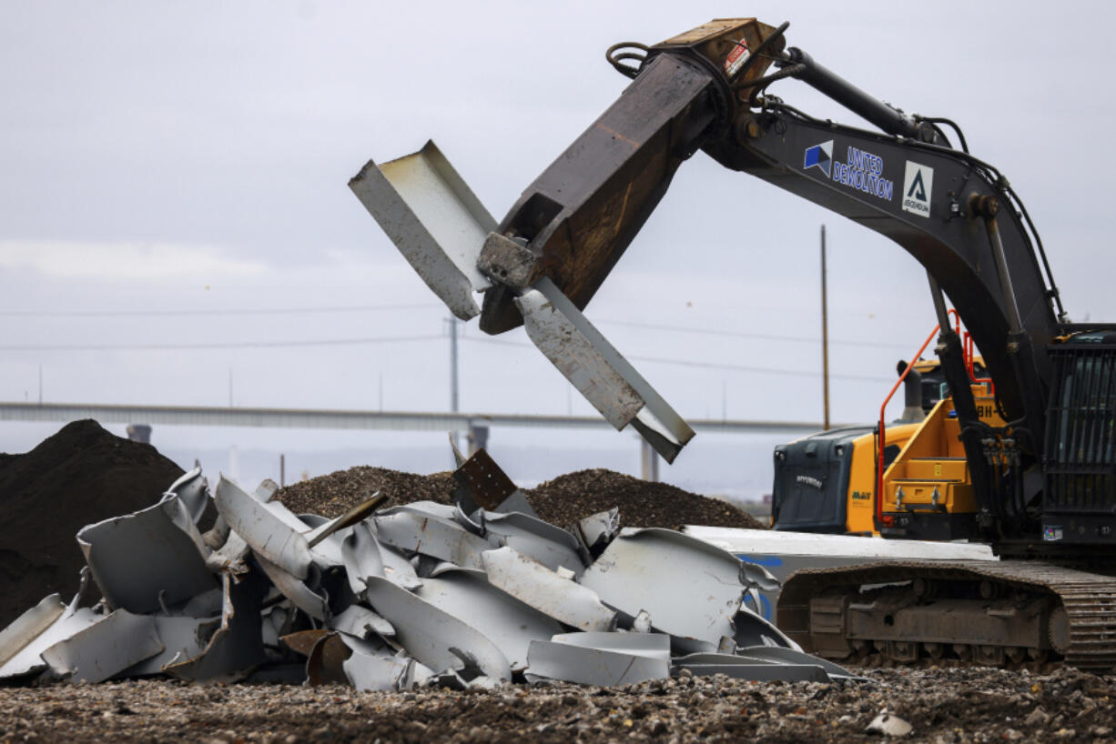 A shearer breaks apart salvaged pieces of the collapsed Francis Scott Key Bridge at Tradepoint Atlantic, Friday, April 12, 2024, in Sparrows Point, Md.