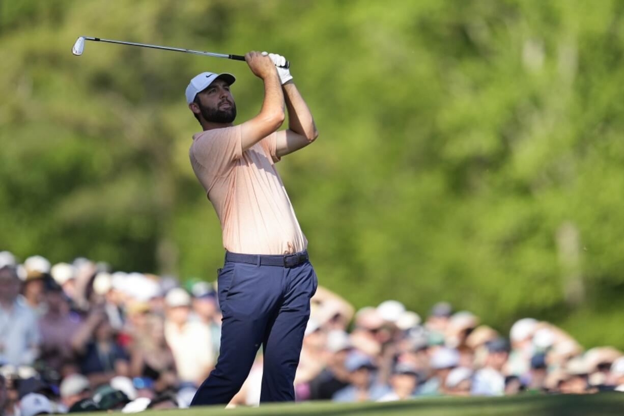 Scottie Scheffler watches his tee shot on the 12th hole during final round at the Masters golf tournament at Augusta National Golf Club Sunday, April 14, 2024, in Augusta, Ga.