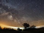 FILE - The Lyrid meteor shower is seen over Burg on the Baltic Sea island of Fehmarn off Germany, Friday, April 20, 2018. The Lyrids occur every year in mid-to-late April. Peak activity for 2024 happens Sunday, April 21 into Monday, April 22, with 10 to 20 meteors expected per hour, weather permitting. Viewing lasts through April 29.