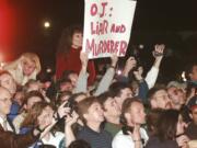 A crowd reacts to O.J. Simpson leaving Los Angeles County Superior Court,on Feb. 4, 1997, in Santa Monica, Calif., after hearing the verdict in the wrongful-death civil trial against Simpson.