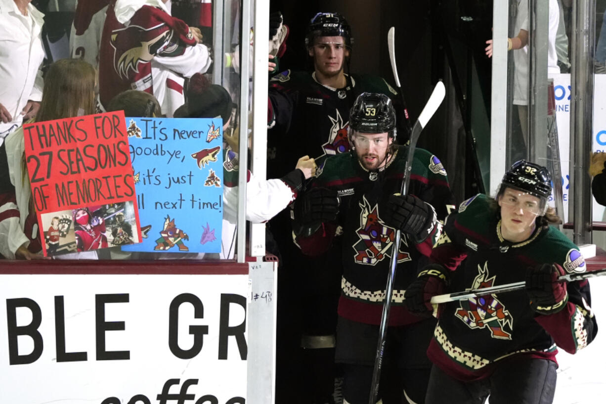 Arizona Coyotes&rsquo; Logan Cooley, right, Michael Carcone (53) and Josh Doan arrive on the ice prior to the team&rsquo;s NHL hockey game against the Edmonton Oilers on Wednesday, April 17, 2024, in Tempe, Ariz. The Coyotes are moving to Salt Lake City in a deal that could be signed less than 24 hours after the game. Hockey could return, perhaps within five years, but the stark reality is this is the end for the foreseeable future. (AP Photo/Ross D.