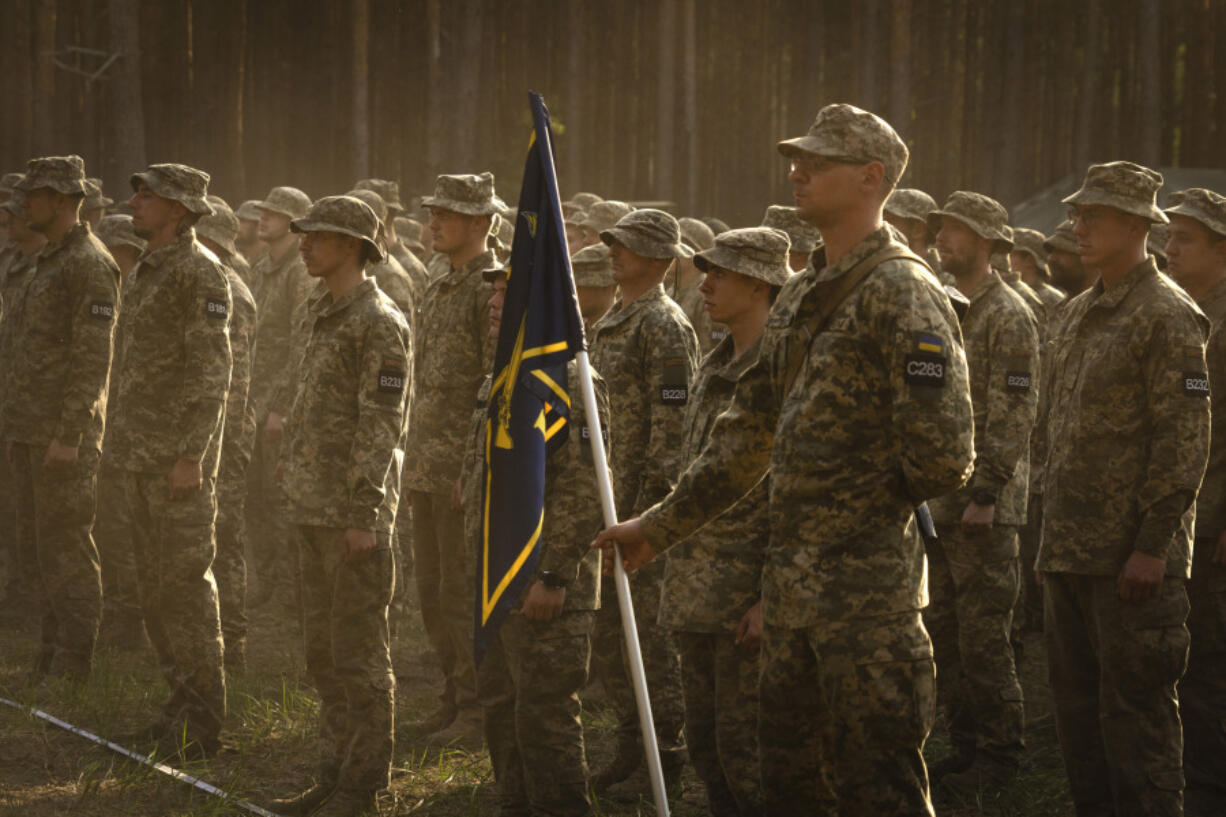 FILE - Newly recruited soldiers attend a ceremony as they celebrate the end of their training at a military base close to Kyiv, Ukraine, Monday, Sept. 25, 2023. Ukraine on Wednesday, April 3, 2024, lowered the military conscription age from 27 to 25 in an effort to replenish its depleted ranks after more than two years of war following Russia&rsquo;s full-scale invasion.