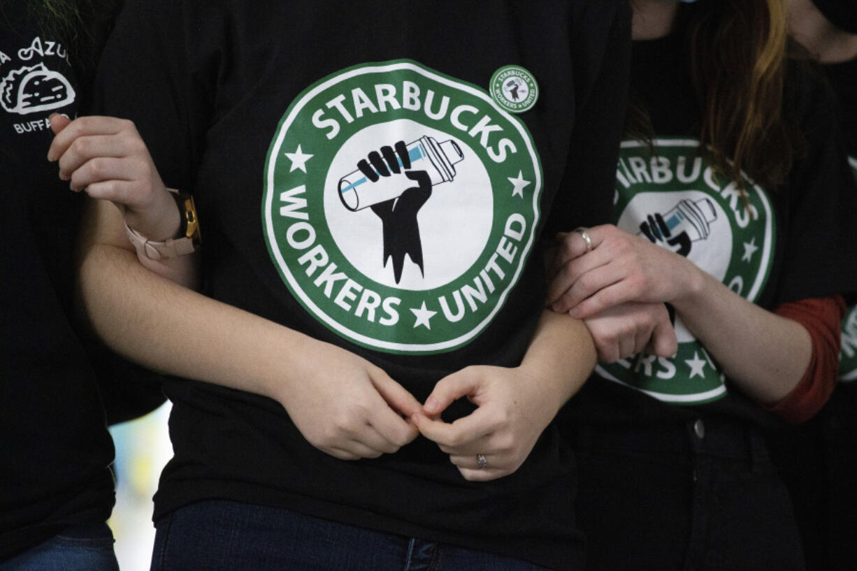 FILE - Starbucks employees and supporters link arms during a union election watch party, Dec. 9, 2021, in Buffalo, N.Y. On Tuesday, April 23, 2024, the Supreme Court is scheduled to hear Starbucks&rsquo; case against the National Labor Relations Board, the federal agency that protects the right of employees to organize. If the court sides with Starbucks, it could make it tougher for the NLRB to step in when it alleges corporate interference in unionization efforts.