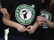 FILE - Starbucks employees and supporters link arms during a union election watch party, Dec. 9, 2021, in Buffalo, N.Y. On Tuesday, April 23, 2024, the Supreme Court is scheduled to hear Starbucks&rsquo; case against the National Labor Relations Board, the federal agency that protects the right of employees to organize. If the court sides with Starbucks, it could make it tougher for the NLRB to step in when it alleges corporate interference in unionization efforts.