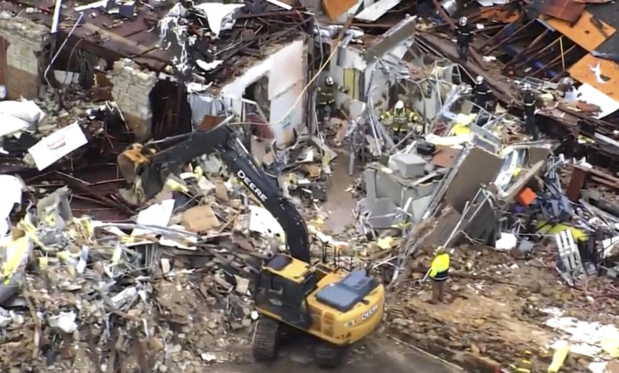 This image taken from video provided by KOCO shows a crew working on clearing debris caused by a tornado in Sulphur, Okla., Sunday, April 28, 2024.