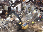 This image taken from video provided by KOCO shows a crew working on clearing debris caused by a tornado in Sulphur, Okla., Sunday, April 28, 2024.