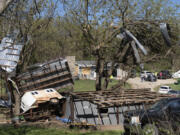 Metal sidings are throw up in trees on Ethan Steenbach&rsquo;s property Tuesday morning in Overbrook, Kan., following a tornado that hit the area. Strong storms have caused damage in parts of the middle U.S. and spawned tornadoes in Kansas and Iowa.