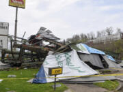 A steel billboard and its support were blown over in Dunbar, W.Va., Tuesday, April 2, 2024, after severe storms blew through the area.