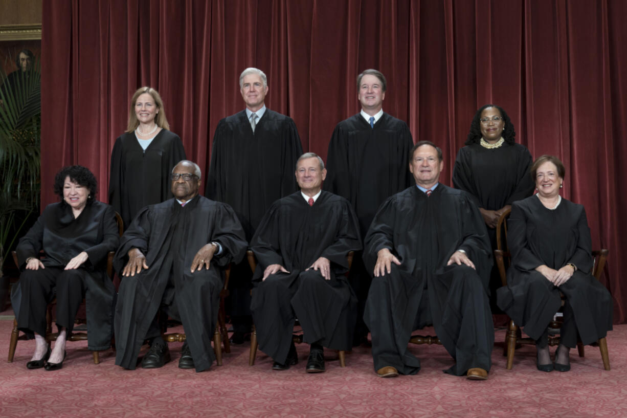 FILE - Members of the Supreme Court sit for a new group portrait following the addition of Associate Justice Ketanji Brown Jackson, at the Supreme Court building in Washington, on Oct. 7, 2022. Bottom row, from left, Associate Justice Sonia Sotomayor, Associate Justice Clarence Thomas, Chief Justice of the United States John Roberts, Associate Justice Samuel Alito, and Associate Justice Elena Kagan. Top row, from left, Associate Justice Amy Coney Barrett, Associate Justice Neil Gorsuch, Associate Justice Brett Kavanaugh, and Associate Justice Ketanji Brown Jackson. The core issue being debated before the Supreme Court on April 25, 2024, boils down to this: Whether a former president is immune from prosecution for actions taken while in office &mdash; and, if so, what is the extent of the immunity? (AP Photo/J.