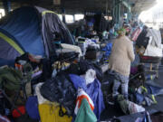 FILE - A woman gathers possessions to take before a homeless encampment was cleaned up in San Francisco, Aug. 29, 2023. The Supreme Court will hear its most significant case on homelessness in decades Monday, April 22, 2024, as record numbers of people in America are without a permanent place to live. The justices will consider a challenge to rulings from a California-based federal appeals court that found punishing people for sleeping outside when shelter space is lacking amounts to unconstitutional cruel and unusual punishment.