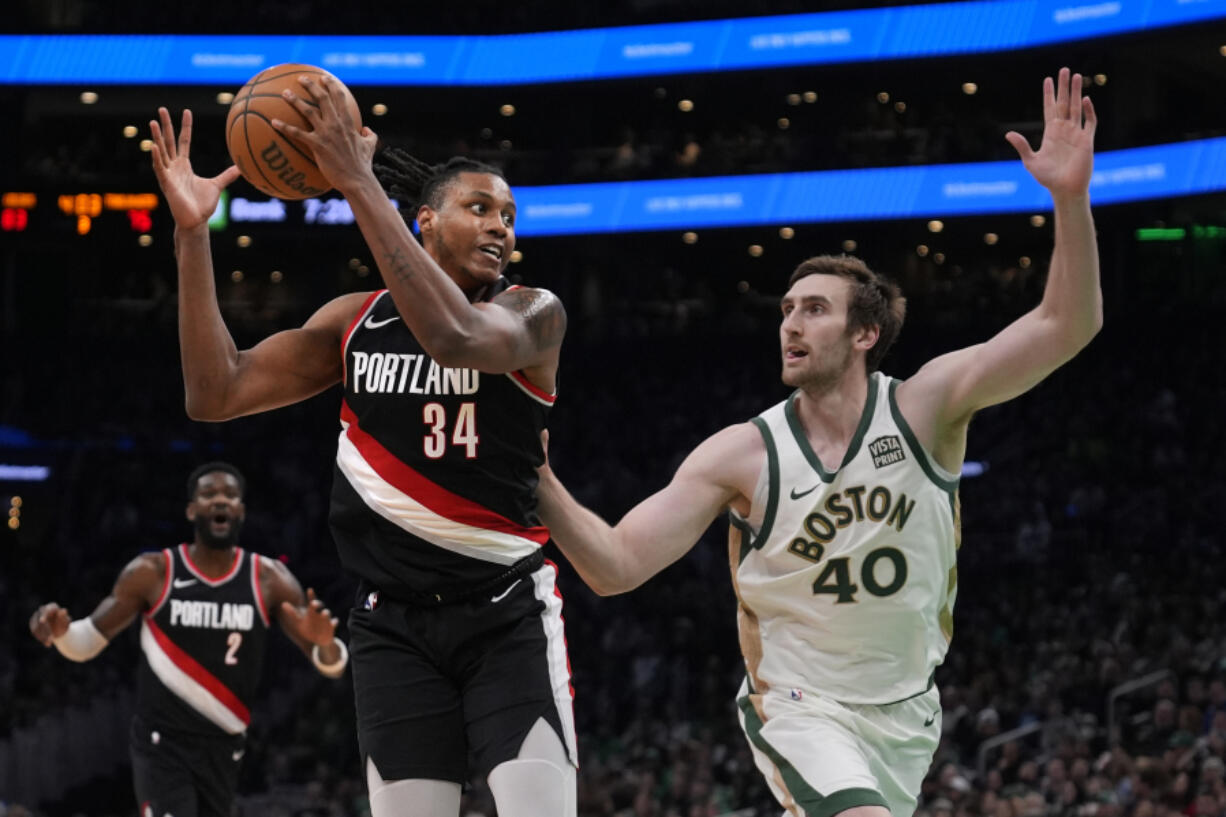 Portland Trail Blazers forward Jabari Walker (34) catches a pass against Boston Celtics center Luke Kornet (40) during the second half Sunday in Boston.