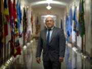 Tracy Toulou, the outgoing Director of the Office of Tribal Justice, stands in a hallway lined with flags of tribal nations at the Department of Justice, Thursday, March 14, 2024, in Washington. For more than two decades, Toulou has confronted the serious public safety challenges facing Indian Country by working to expand the power of tribal justice systems. Today, tribal law enforcement finally has a seat at the table when federal authorities coordinate with state and local police, according to the Justice Department&rsquo;s point person on Native American tribes.