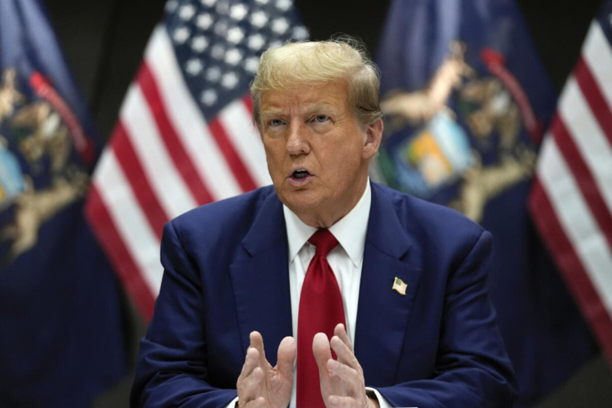 FILE - Republican presidential candidate former President Donald Trump speaks at a campaign event in Grand Rapids, Mich., Tuesday, April 2, 2024. Trump filed a law suit on March 24, suing two co-founders of Trump Media &amp; Technology Group, the newly public owner of his Truth Social platform, arguing that they should forfeit their stock in the company after allegedly setting it up improperly.