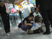 A traveller pets the airport therapy dog Kuki on April 3 while walking through Istanbul Airport in Turkey. Istanbul Airport has made five new hires to provide stress-free travel experience for anxious passengers: therapy dogs that are ready to offer support with snuggles, belly rubs and sloppy kisses.