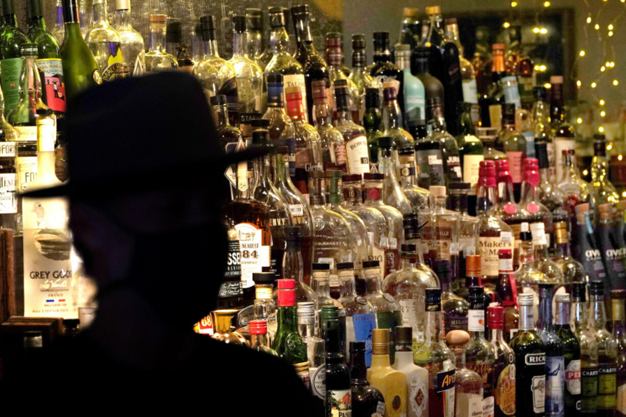 Bottles of alcohol sit on shelves at a bar in Houston. Moderate drinking was once thought to have benefits for the heart, but better research methods starting in the 2010s have thrown cold water on that.
