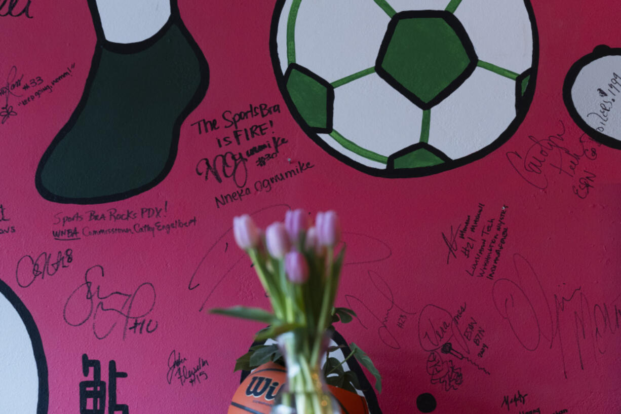 Autographs from WNBA commissioner Cathy Engelbert and professional basketball player Nneka Ogwumike are seen on the wall at The Sports Bra sports bar on Wednesday, April 24, 2024, in Portland, Ore. Ogwumike now plays for the Seattle Storm.