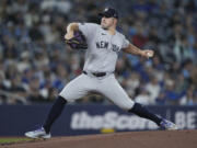 New York Yankees pitcher Carlos Rodon works against the Toronto Blue Jays during the first inning of a baseball game in Toronto on Tuesday, April 16, 2024.