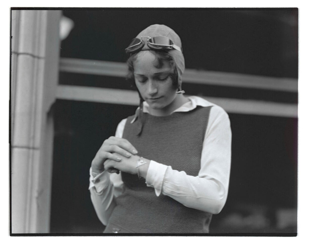 Dorothy Hester examines a silver bracelet she received in November 1930 for her stunt flying accomplishments. She held the world&rsquo;s record for 69 outside loops &mdash; 62 deemed perfect circles &mdash; for 58 years until it was broken in 1989.