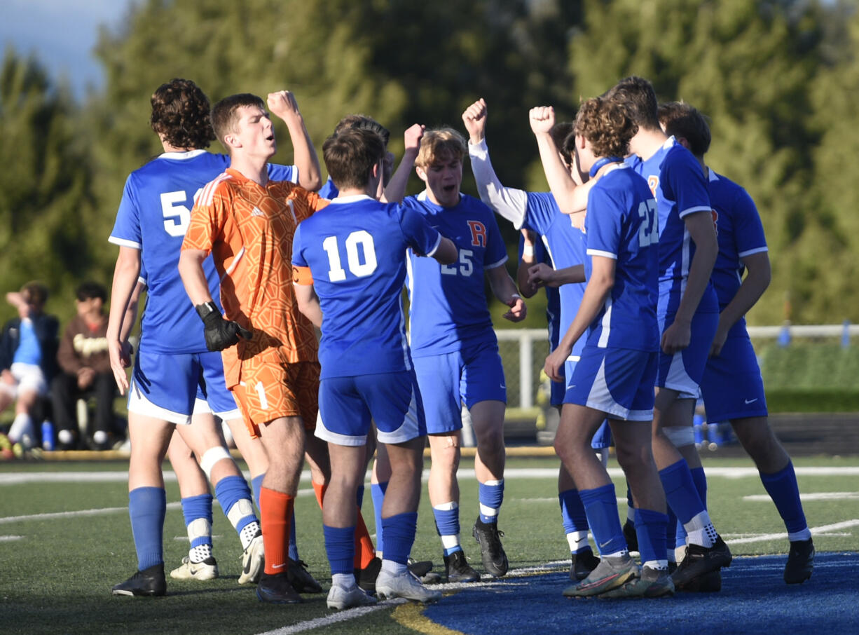 Ridgefield players break from a huddle on the field prior to the start of the second half of the Class 2A District 4 boys soccer pigtail game against Aberdeen on Thursday, May 2, 2024, at Ridgefield High School.