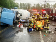 Crews from Clark-Cowlitz Fire Rescue extracted a driver from an overturned concrete mixer truck Saturday.