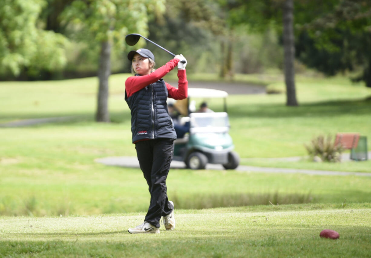 Camas' Jacinda Lee watches her tee shot on the 15th hole during the Class 4A District 4 girls golf tournament on Tuesday at Lewis River Golf Course. Lee won for the third year in a row, this time by 16 strokes.