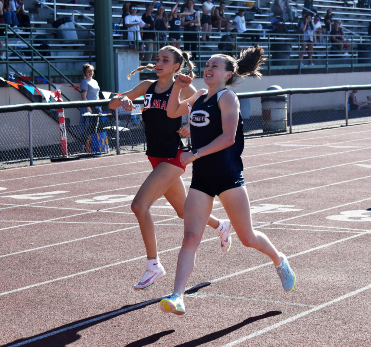 Daphne Evenson of Skyview (right) celebrates as she beats Eliisa Marshall of Camas to the finish line of the 4A girls 800 meters at the 4A/3A Greater St. Helens League district track and field meet at McKenzie Stadium on Thursday, May 9, 2024.