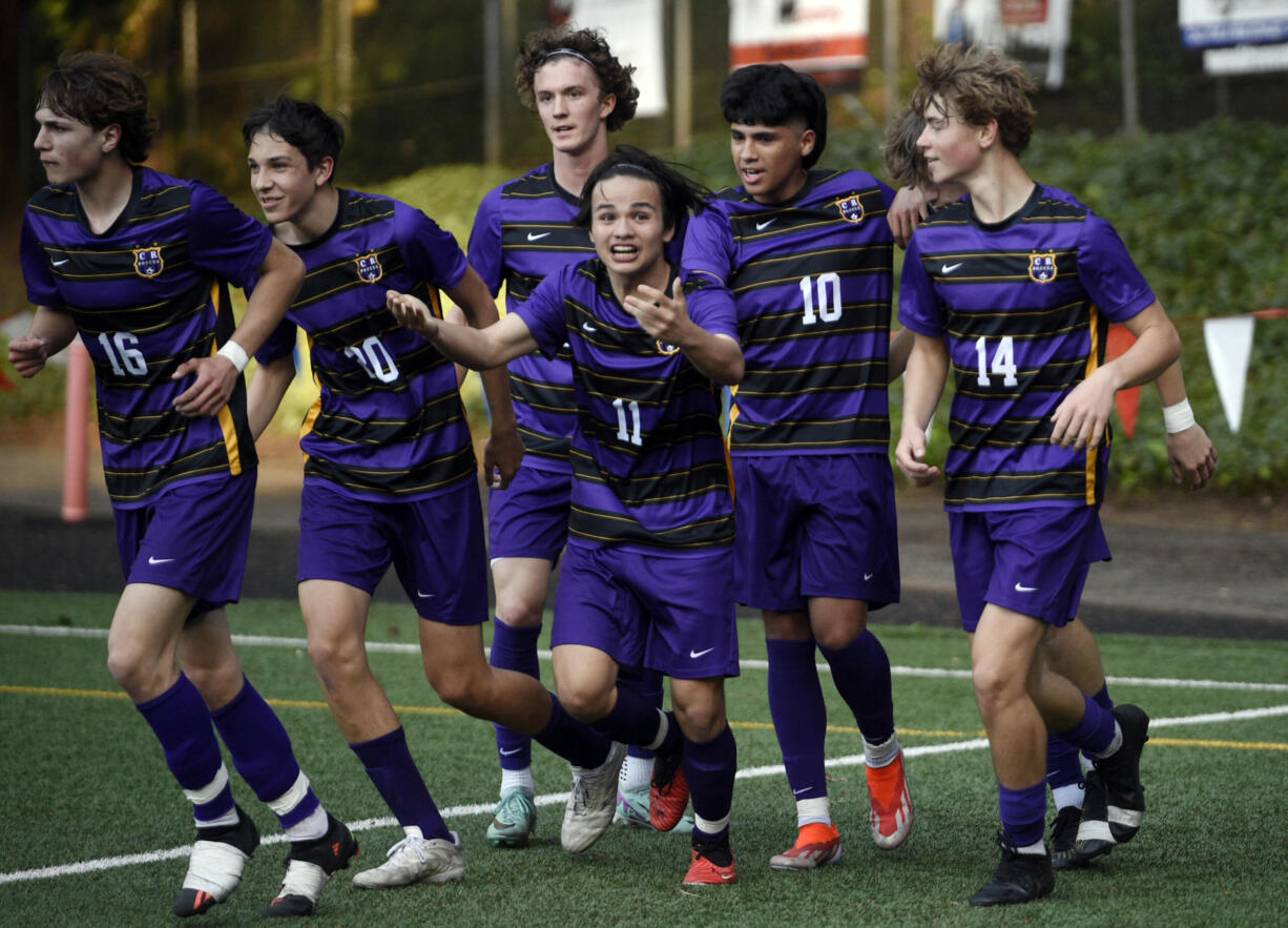 Columbia River's Beckham Young (11) signals to the crowd to get loud after a goal scored by JP Guzman (10) during the Class 2A district boys soccer championship against R.A. Long, on Thursday, May 9, 2024, at Kiggins Bowl.