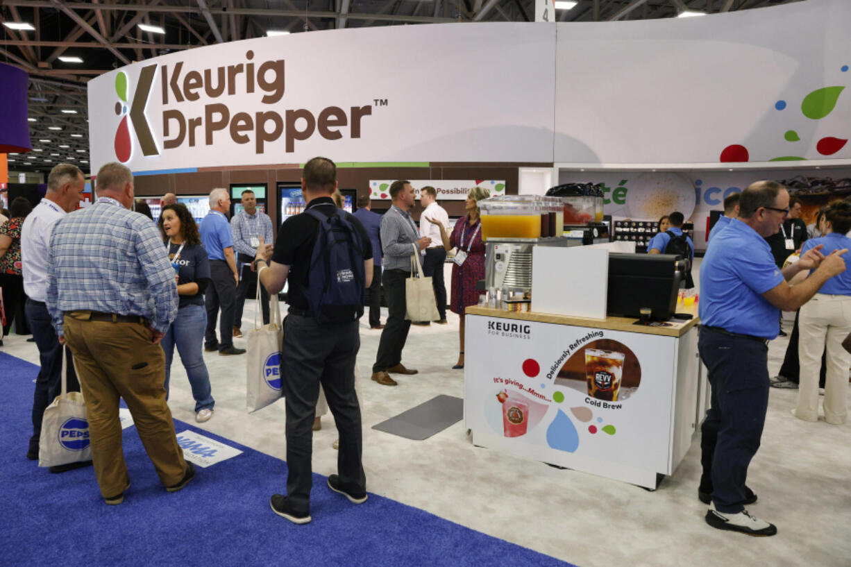 Attendees visit the Keurig Dr Pepper booth during the National Automatic Merchandising Association 2024 show this week in Dallas.